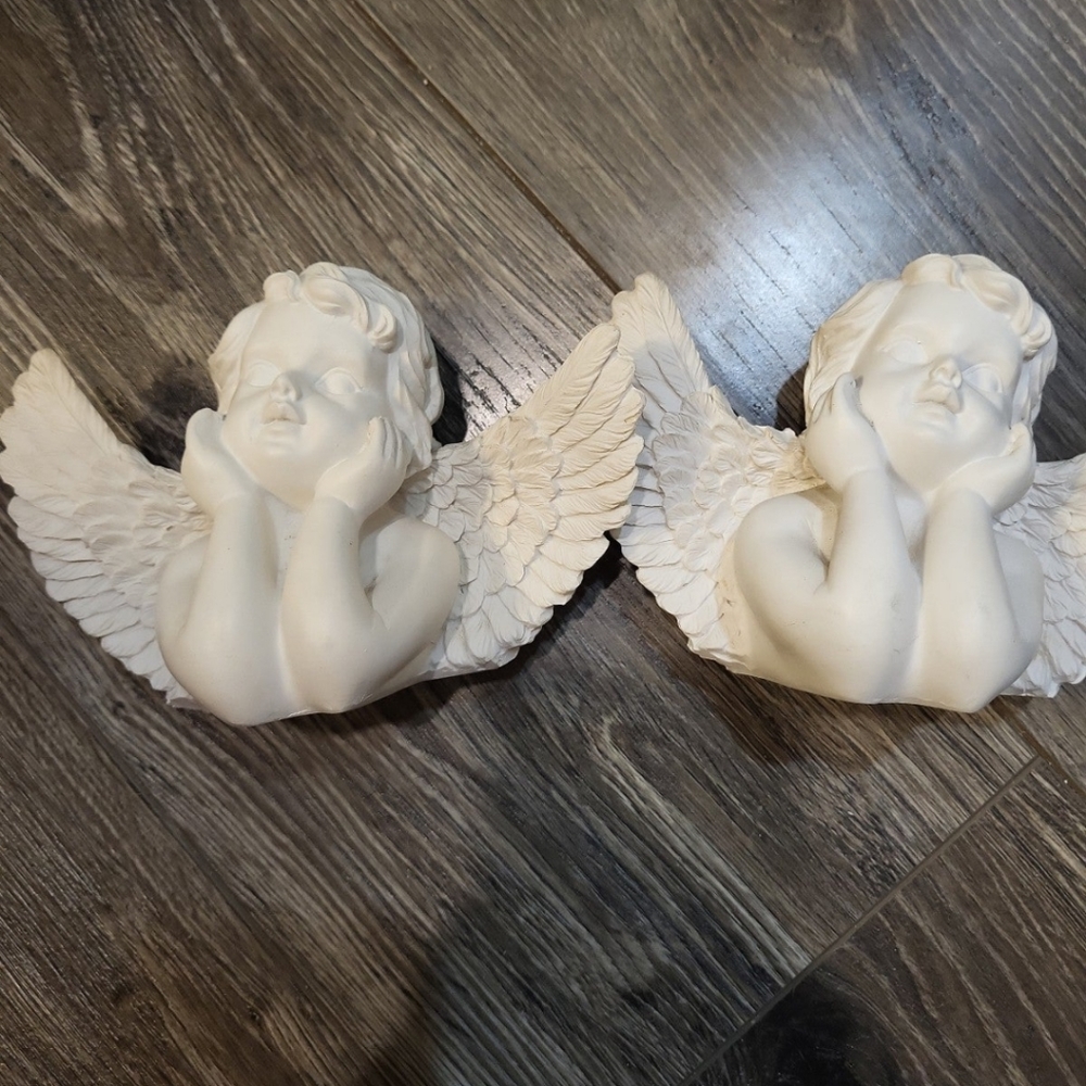 Matching cherub figures
